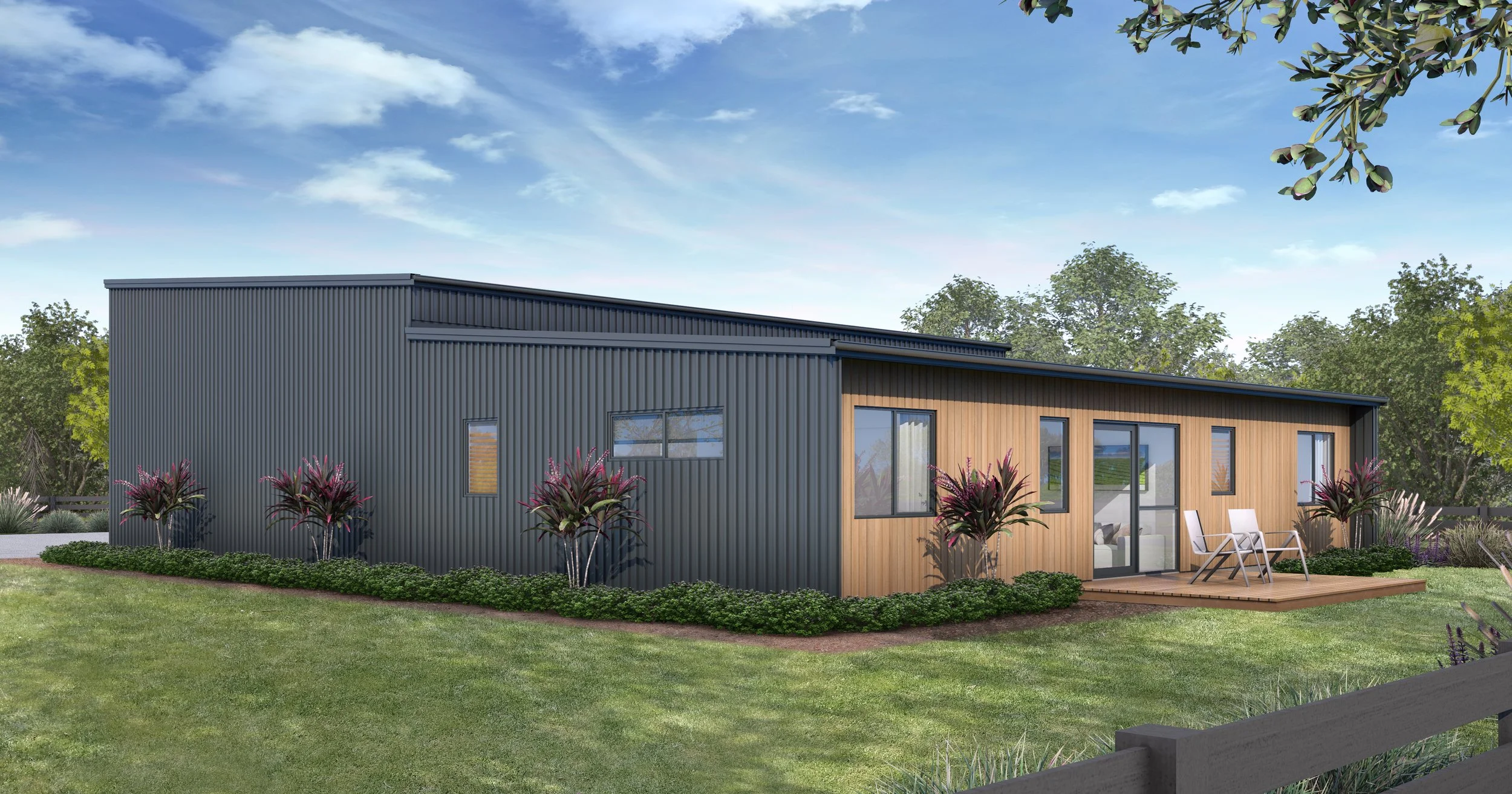 A modern house with a metal siding on one side and wooden siding on the other, featuring a small deck with two chairs and a sliding glass door, surrounded by a well-manicured lawn and landscaped plants.