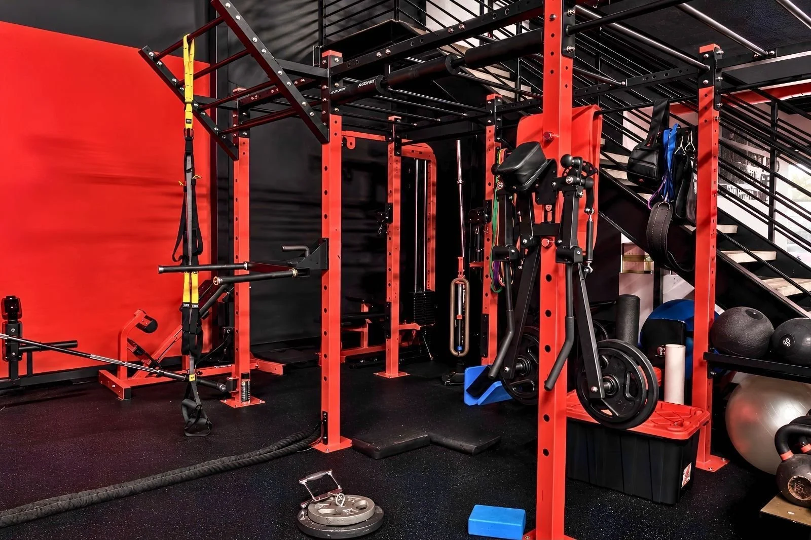Functional training zone with a training rig, suspension trainers, and conditioning equipment.
