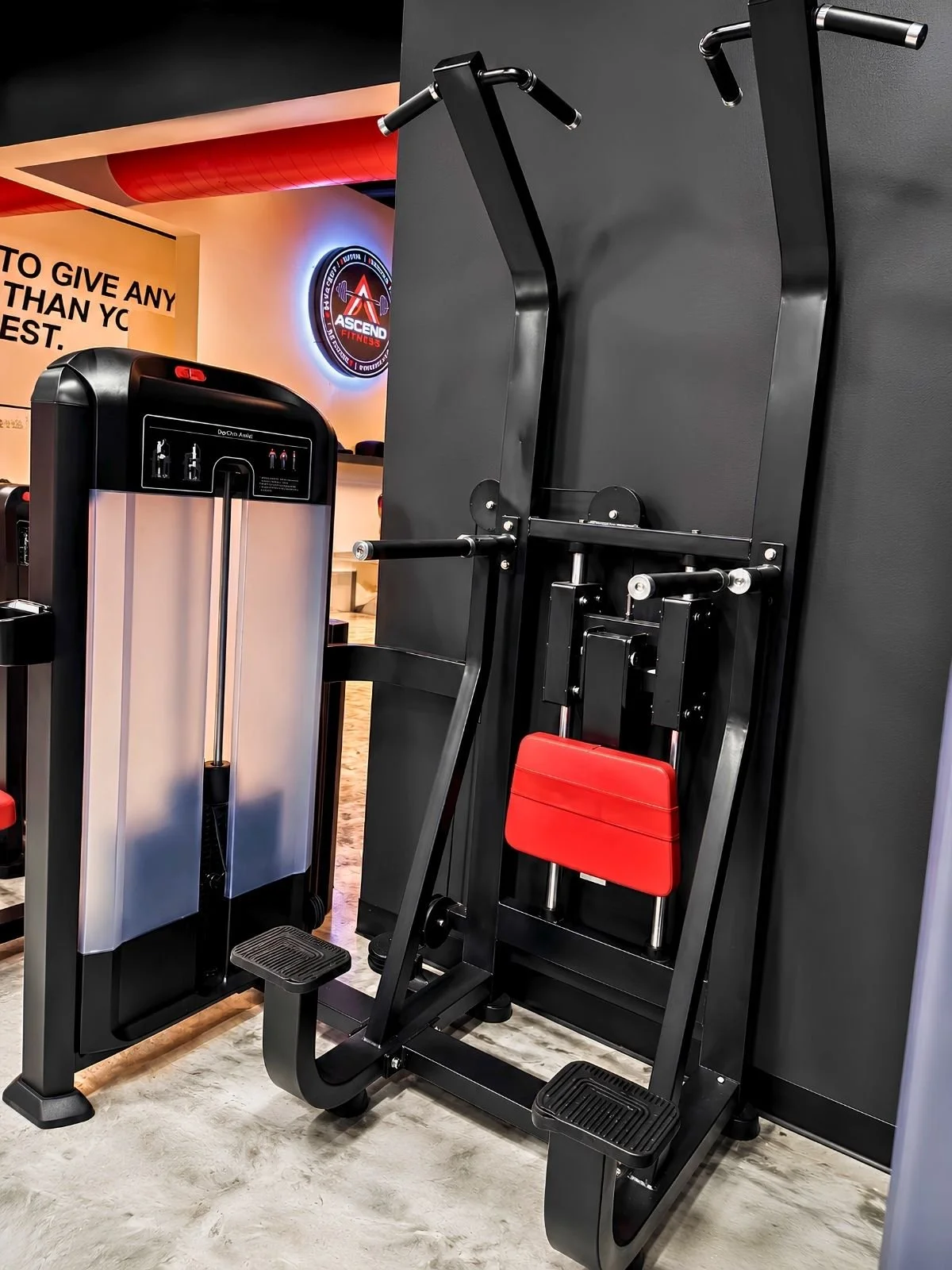 Assisted pull-up and dip machine in the strength training area.