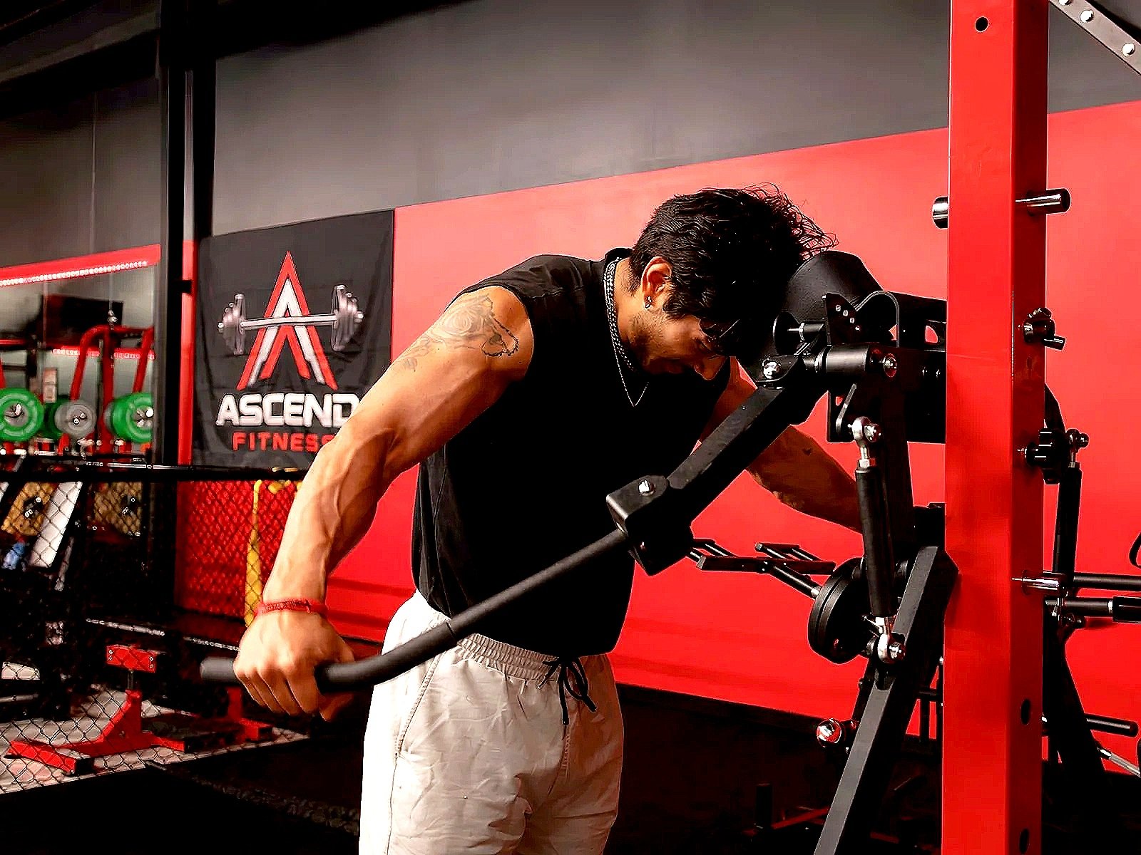 A man working out on a weight machine at Ascend Fitness Cypress.