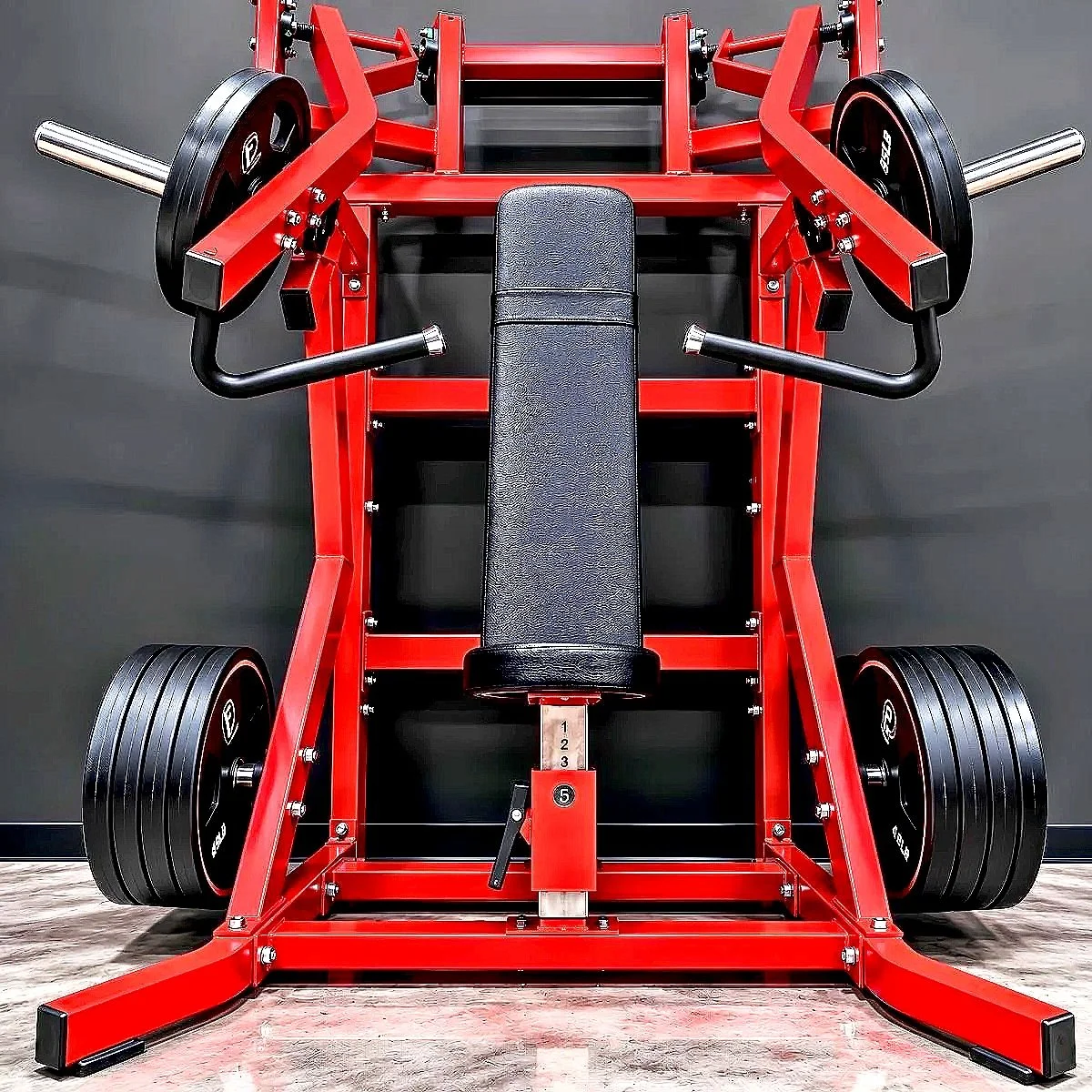 Top view of a red and black weightlifting bench press station with large black weight plates on each side.
