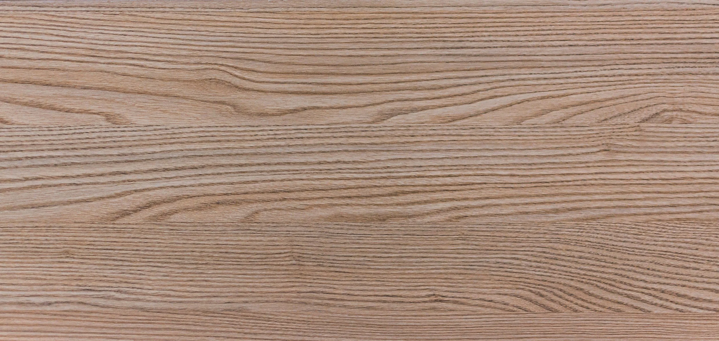 Close-up of a wooden surface with visible wood grain patterns.