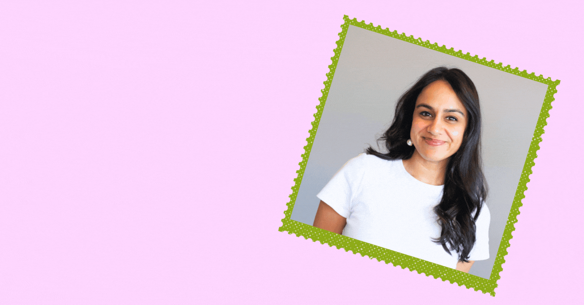 A woman with long dark hair, wearing a white shirt and a pearl earring, smiling at the camera, in a framed photo on a light purple background.