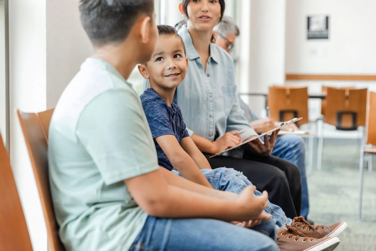Smiling child with sibling and social worker