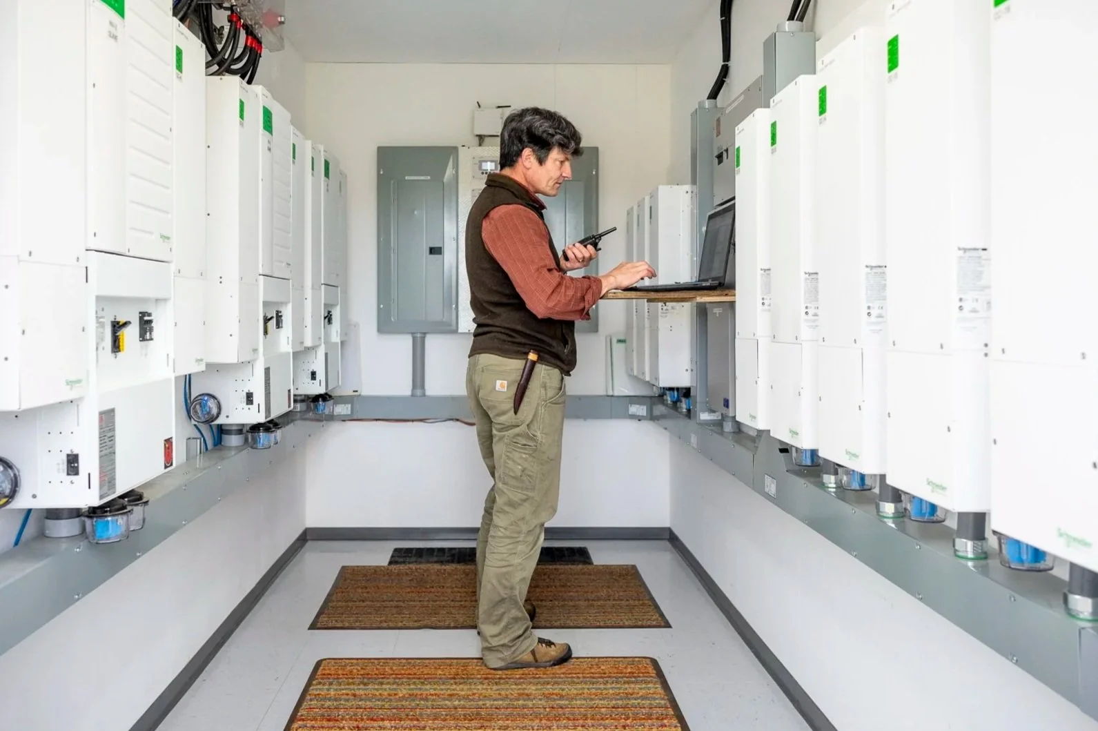 Simon in the solar battery room at Camp Denali