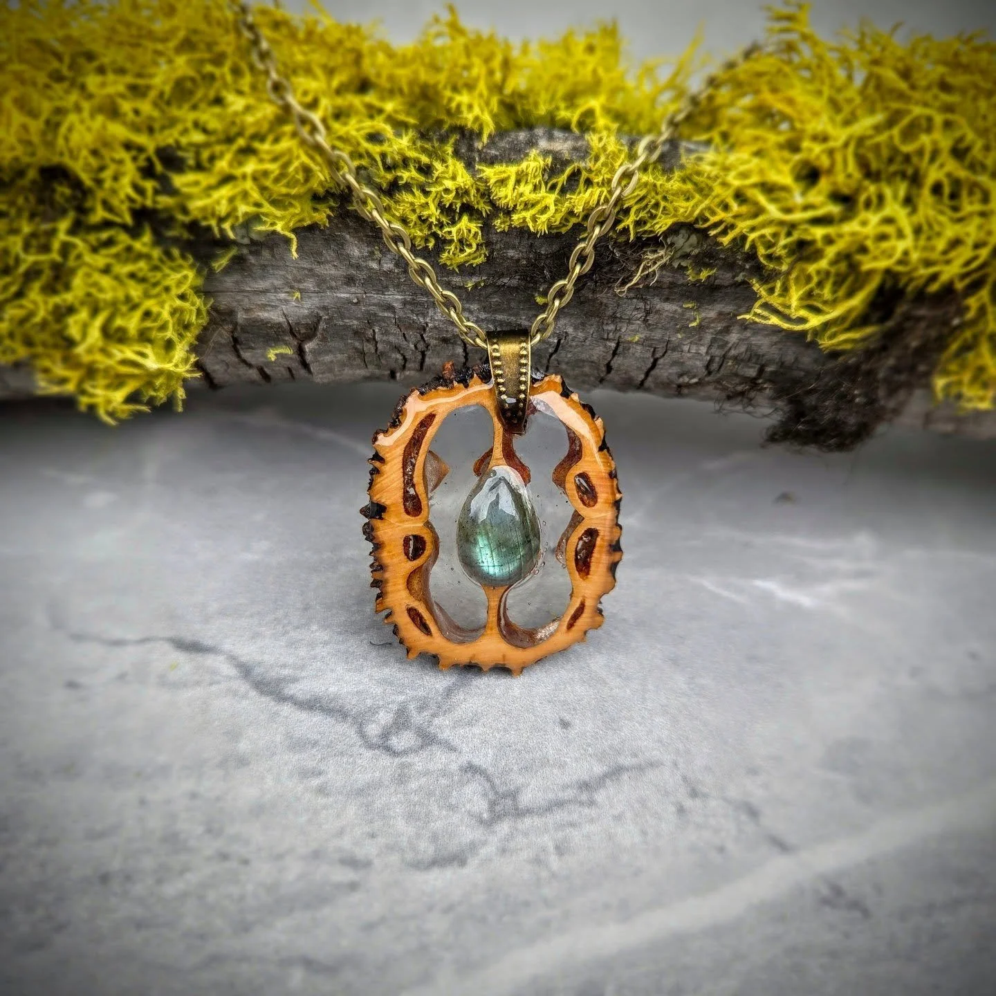 Nature hides the most beautiful designs.

This pendant was created from a real walnut shell, carefully cut to reveal the organic patterns inside, and finished with a glowing labradorite stone at the center.

Every piece is one of a kind &mdash; shape