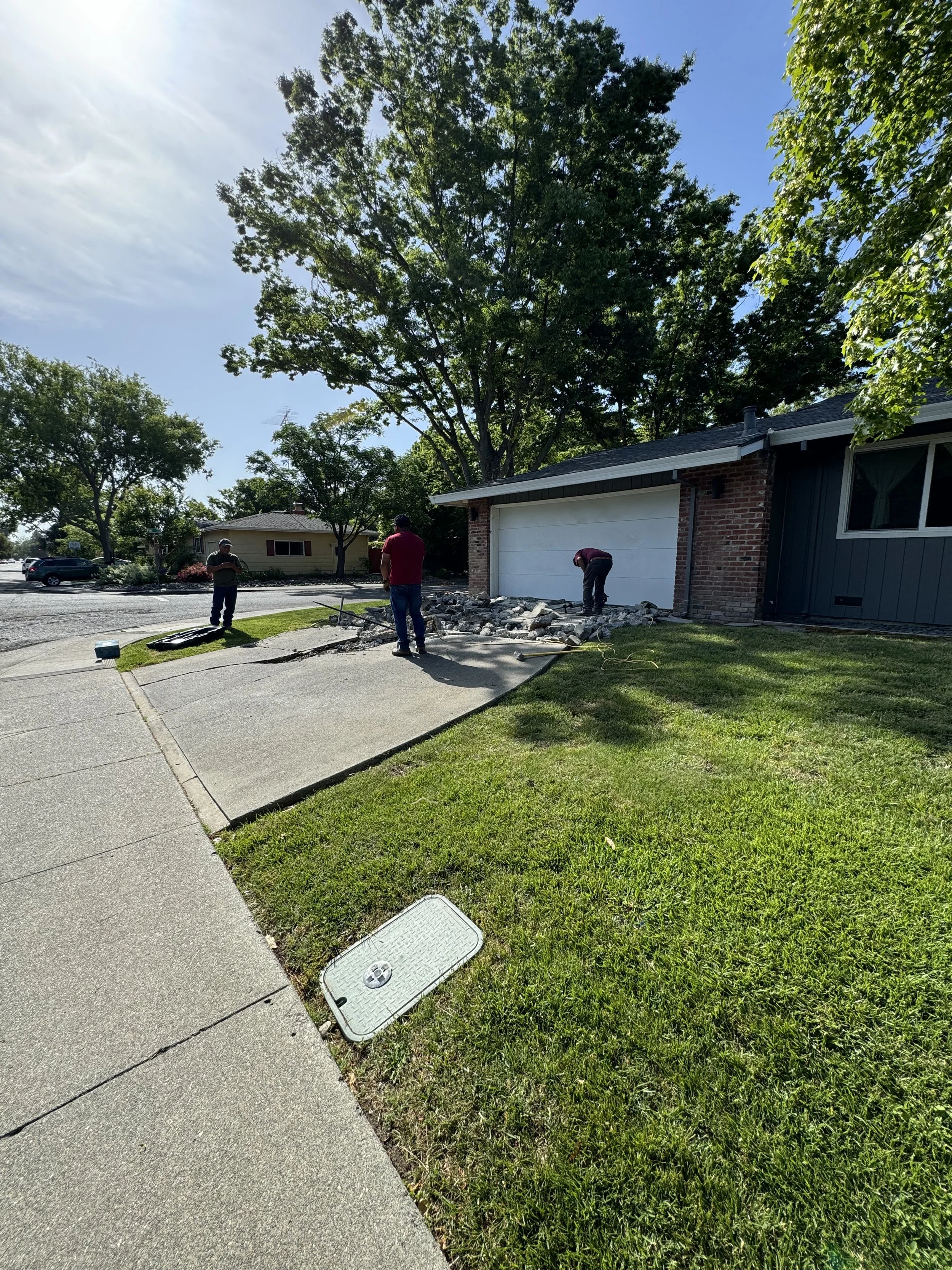 Professional crew breaking and removing concrete driveway for new installation in Vacaville California