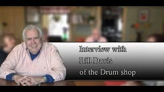Screenshot of a television interview with Bill Davis from the Drum shop, featuring a woman off-screen.