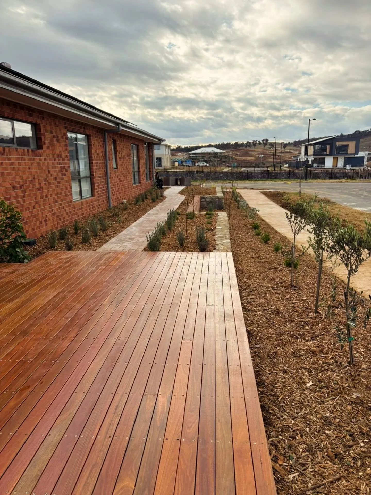 From start to finish on this new build. 
Our team just completed this awesome project on this completely empty block 

All Work completed in-house 
Exposed aggregate driveway 
Recycled concrete walls
Brick walls/bench seats and mailbox 
Tiling 
Spott