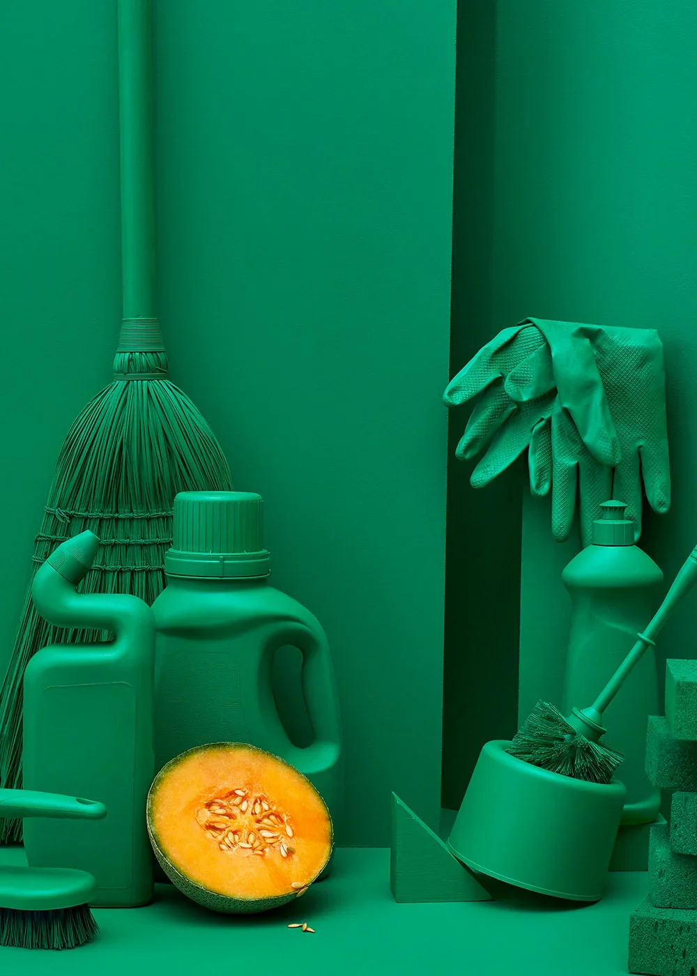 Still life creative photography prop styled and art directed by rayna marlee. Cleaning supplies including a broom, gloves, detergent bottles, and a scrub brush, with a half-cut melon in front, all in a monochrome teal color scheme.