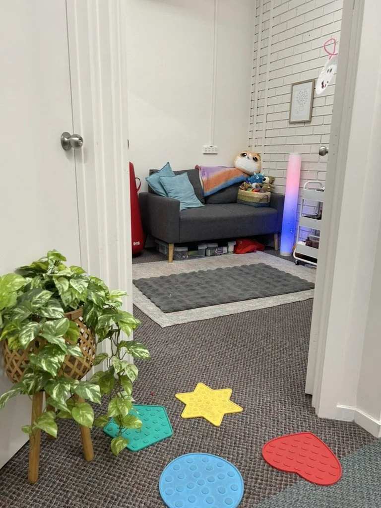 Inside the Flourish Within therapy room, with a couch and sensory toys
