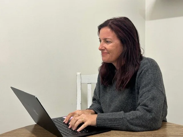 Sarah Everett working at her laptop