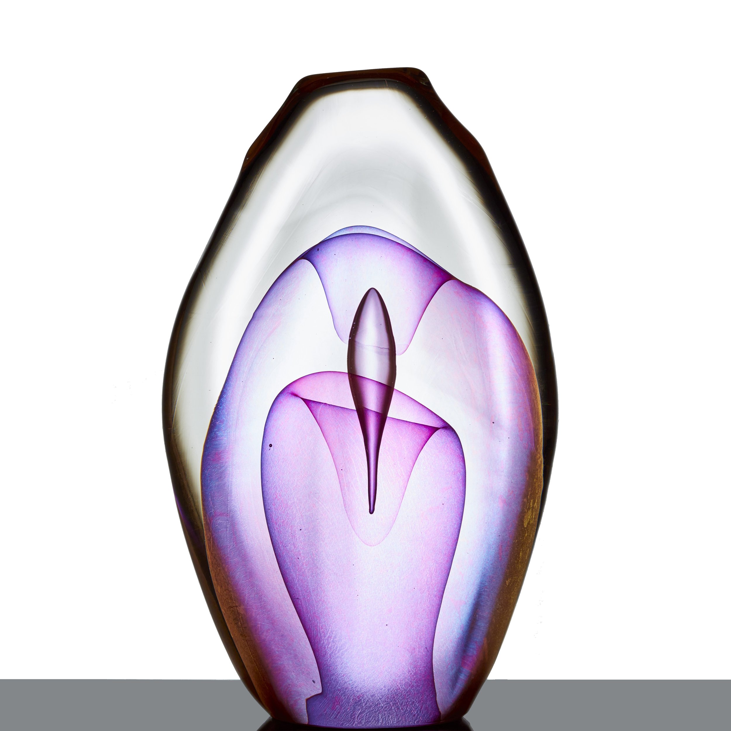 A oval clear and purple glass sculpture with shapes inside it.