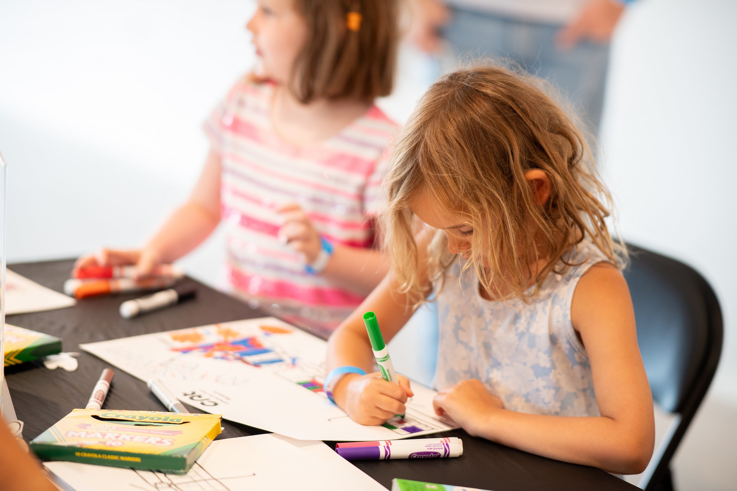 Girls coloring with markers.
