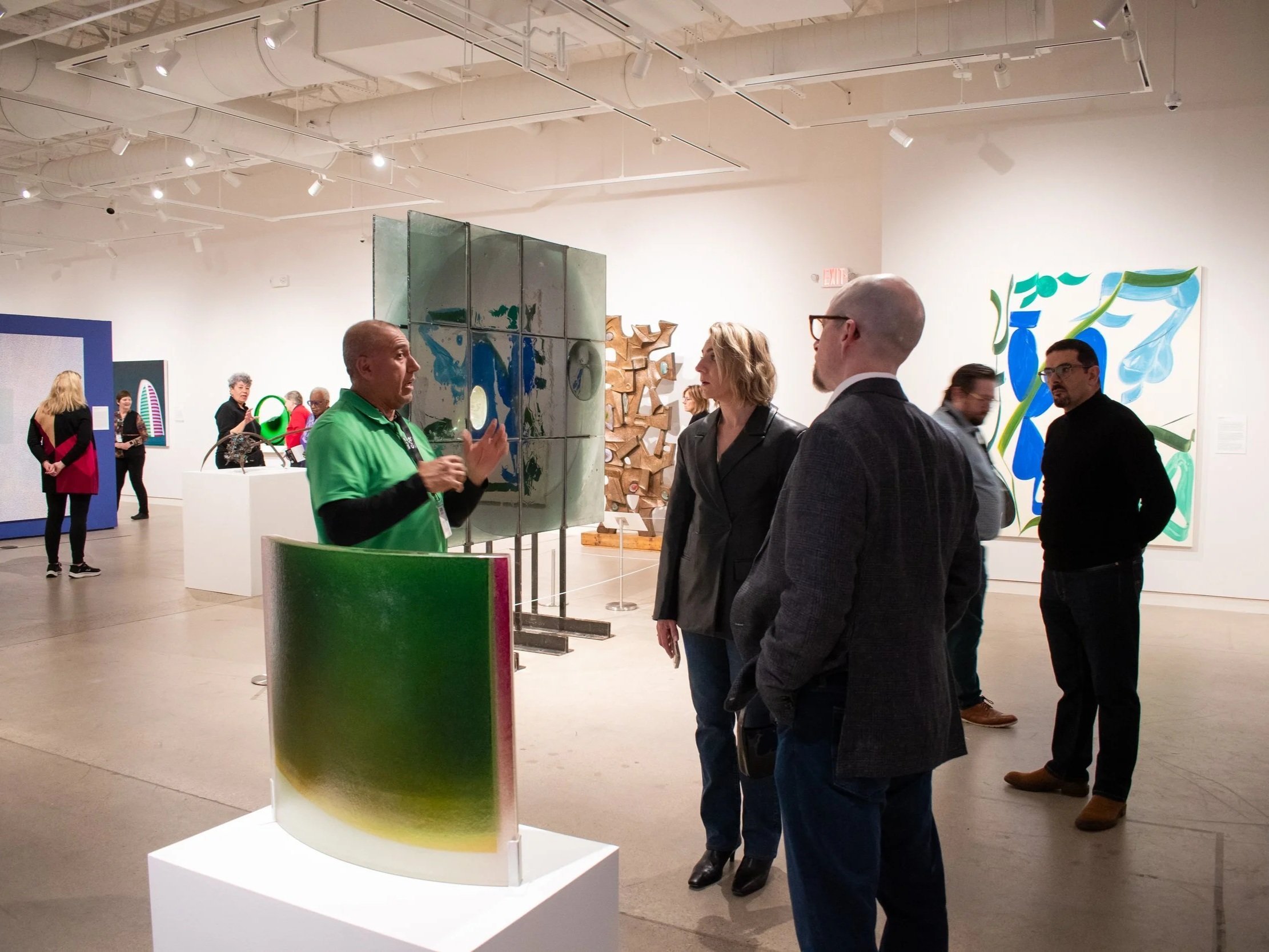 People viewing contemporary artwork in an art gallery.