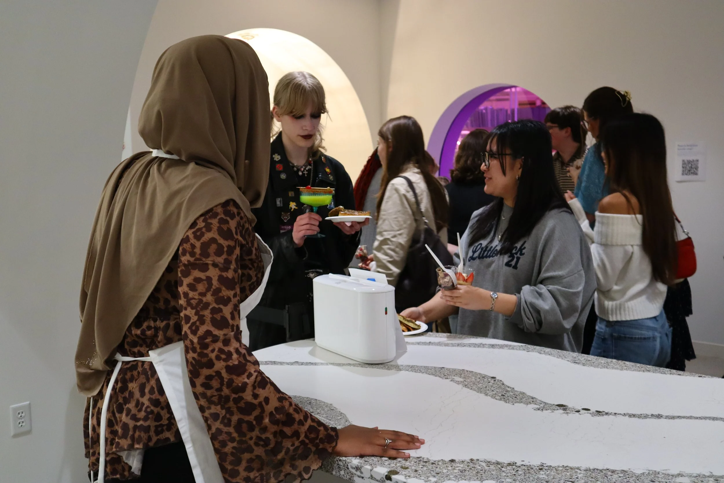  Teens gather to eat and drink while a member of the teen council serves them.  