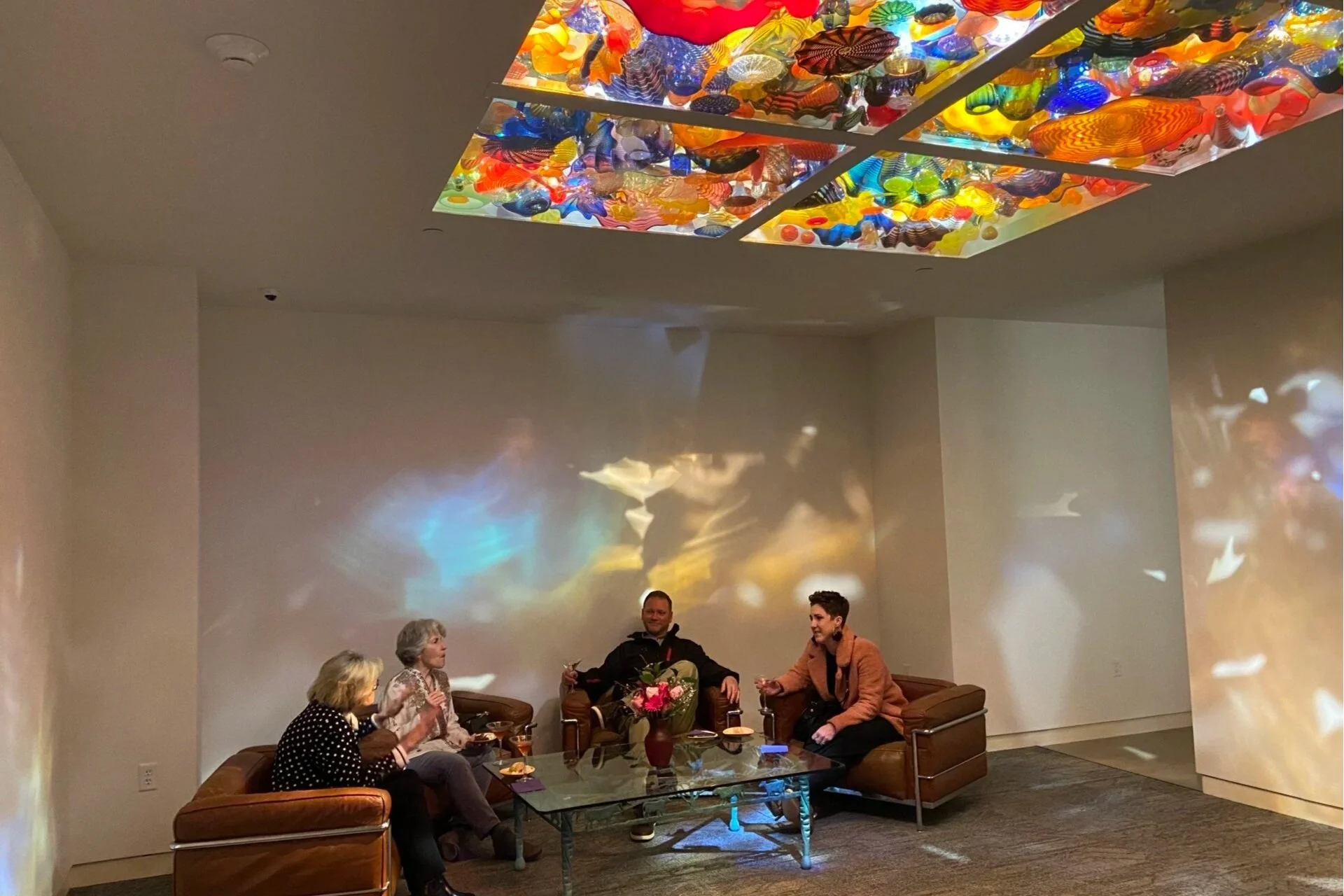 People seated in the Pergola Ceiling room enjoying drinks and socializing.