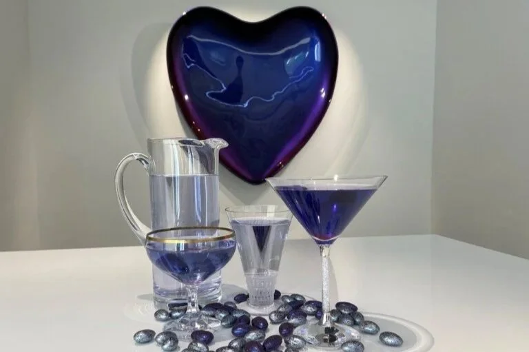 An arrangement of cocktails in front of the CAT's Purple Heart sculpture by Tommy Tanggara.
