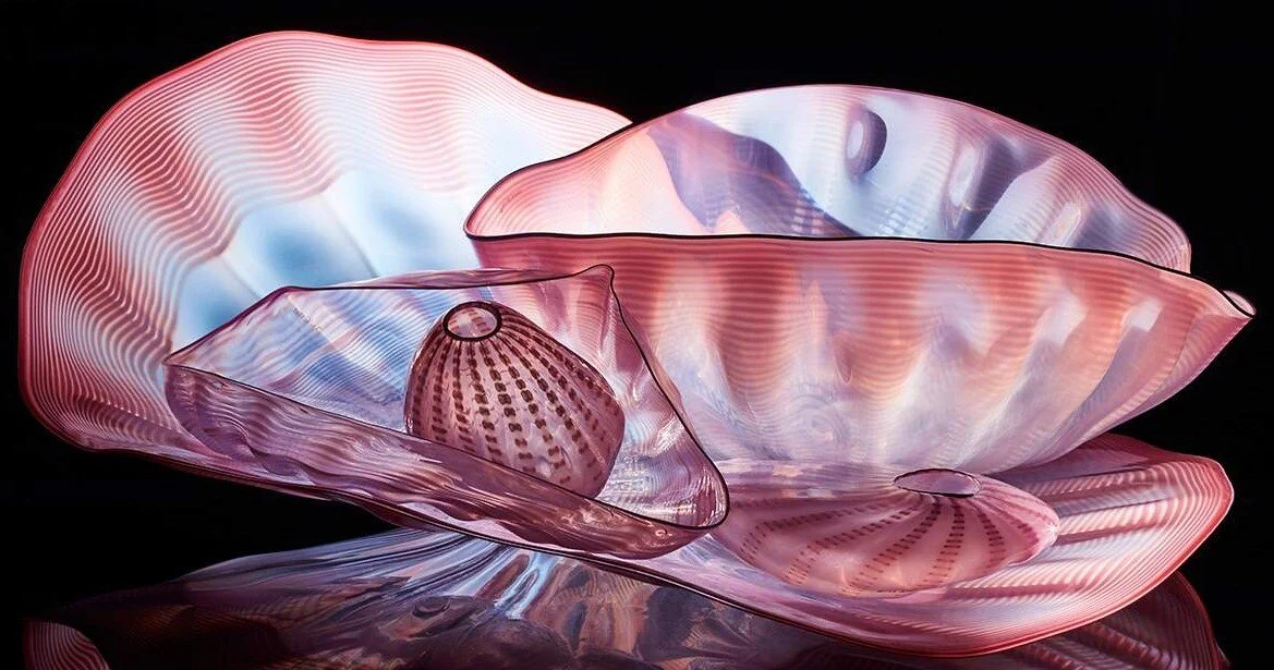 A pink, purple, and blue wavy glass sculptural form by artist Dale Chihuly.
