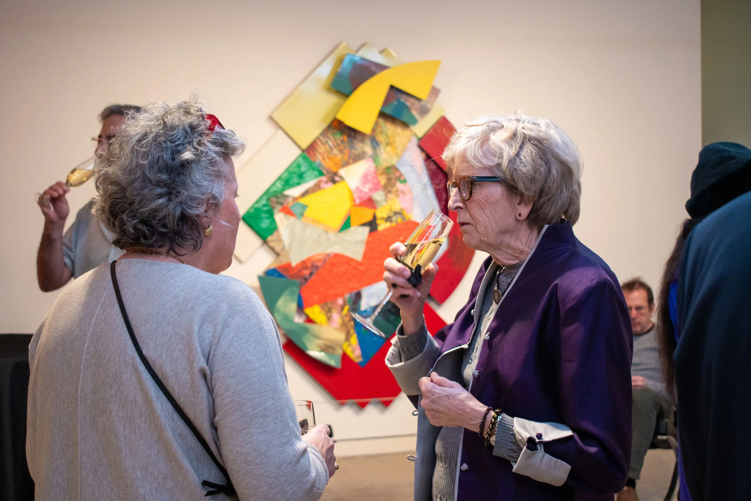Women sipping champagne in the museum lobby.
