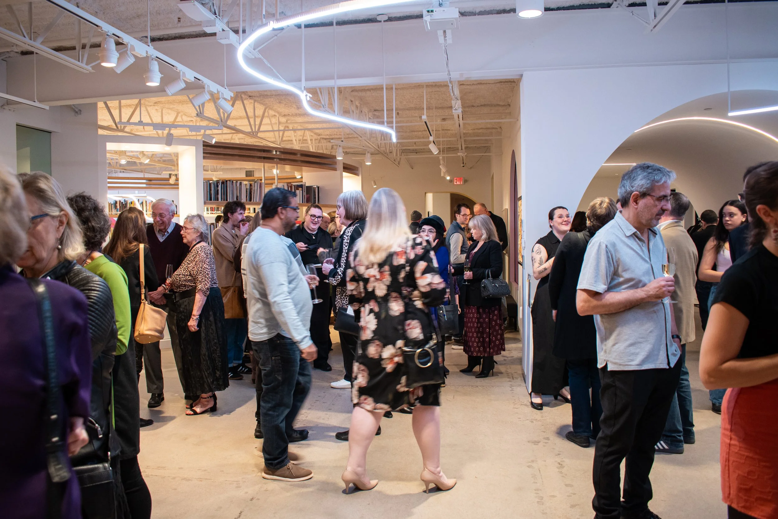 A crowded museum lobby filled with party guests.