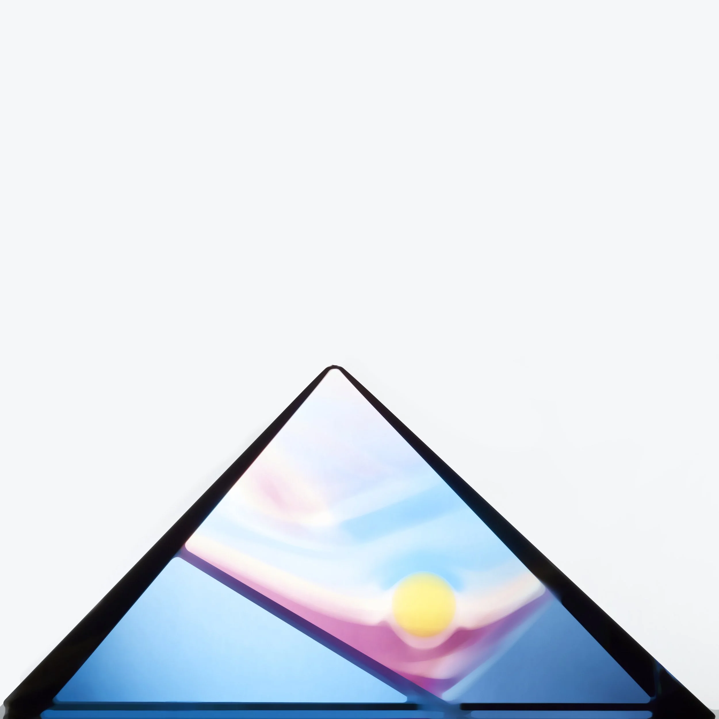 A blue pyramid glass sculpture with a yellow circle inside it.