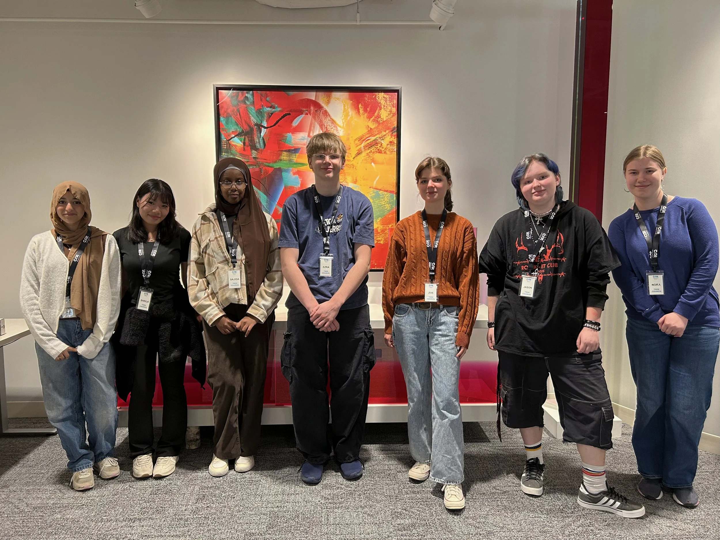 The seven members of the 2025 Teen Council posing in a straight line.