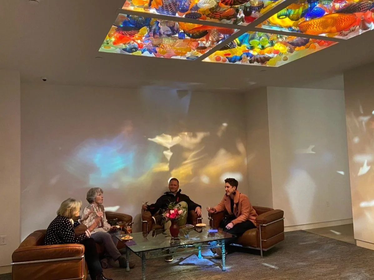 People seated in the Pergola Ceiling room enjoying drinks and socializing.