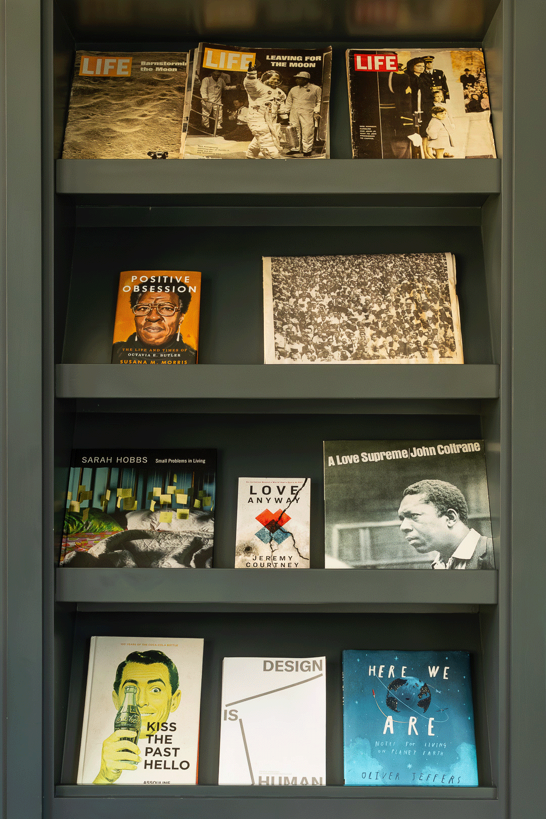 Bookshelves with various books including titles about history, love, design, and science, arranged on multiple shelves.