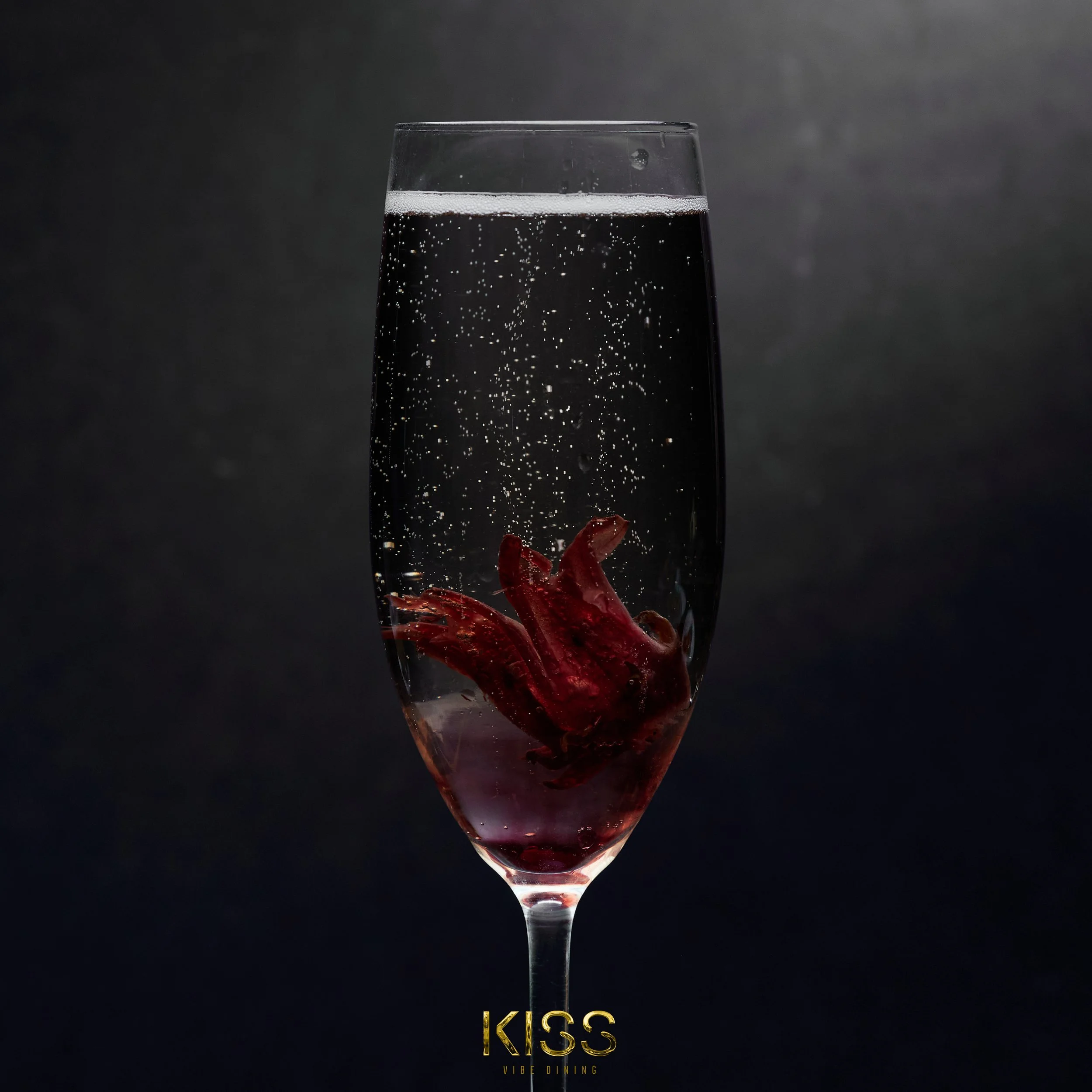 A glass of dark sparkling beverage with an octopus inside.