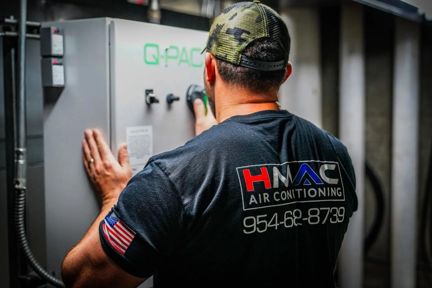 Technician servicing HVAC air conditioning unit in the basement