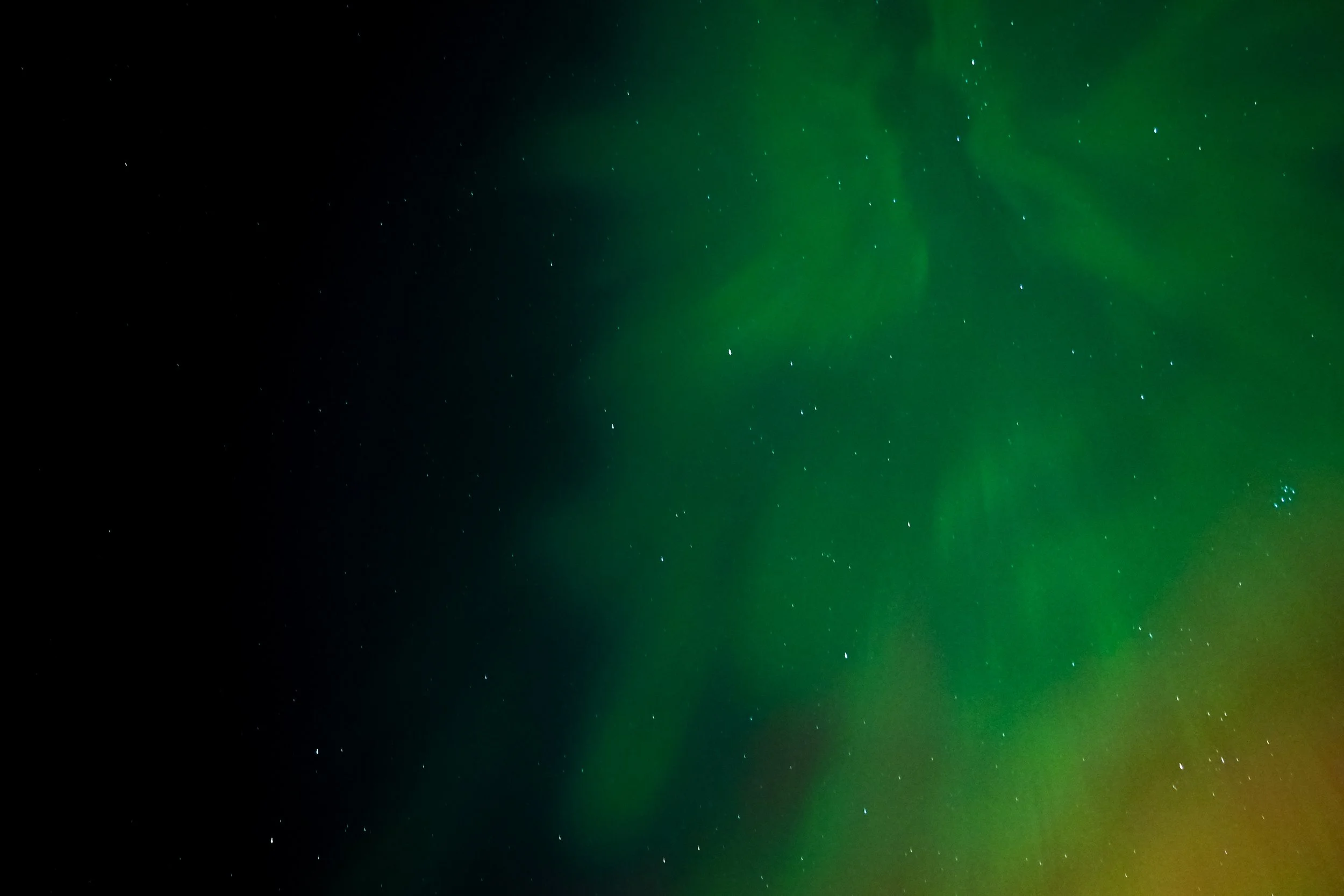 Northern Lights (Aurora Borealis) in the night sky with stars.