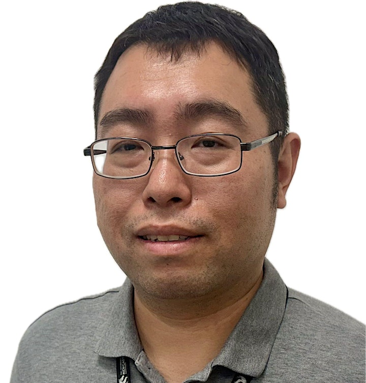 Portrait of a man with short black hair, glasses, and a gray collared shirt against a white background.