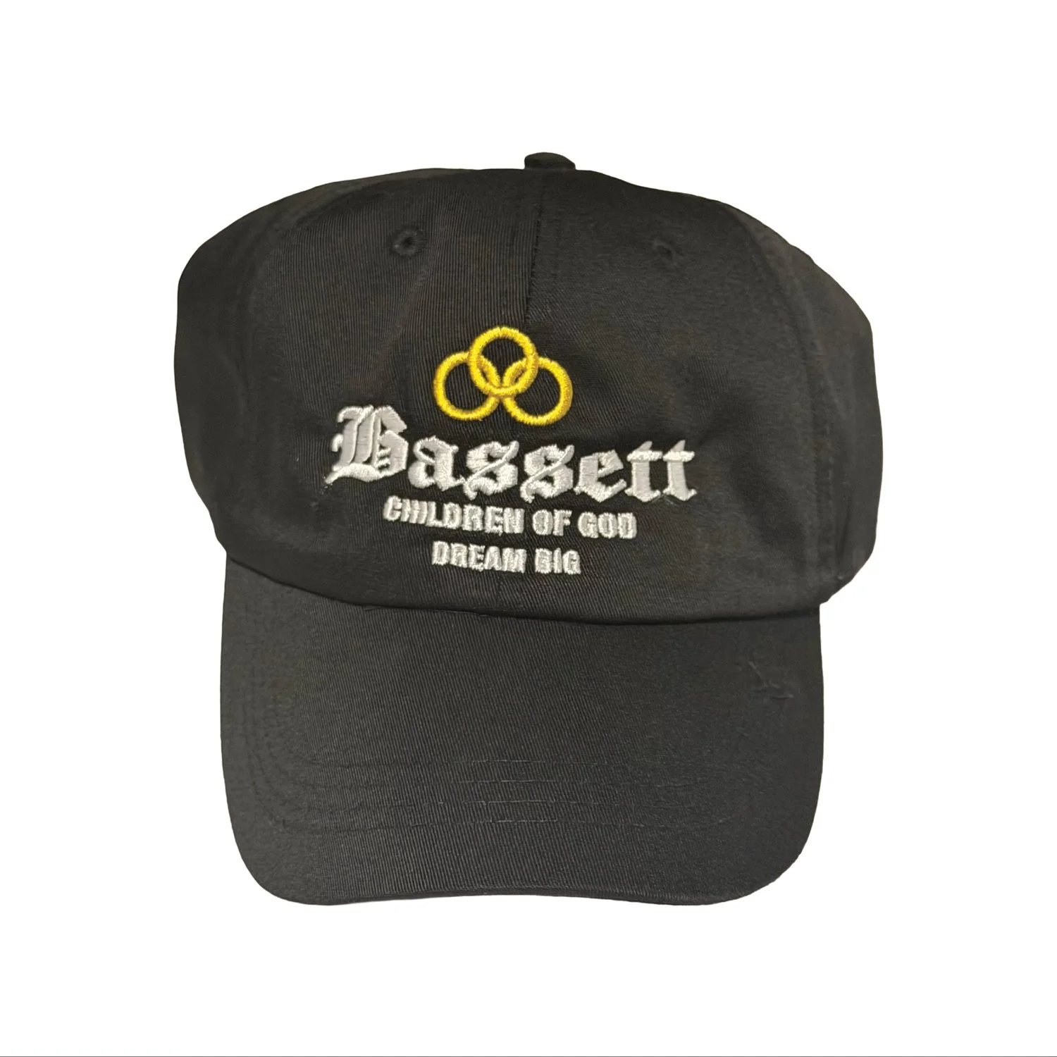 Black baseball cap with yellow intertwined rings logo and embroidered white text reading "Basket" and smaller text "Children of God Dream Big".