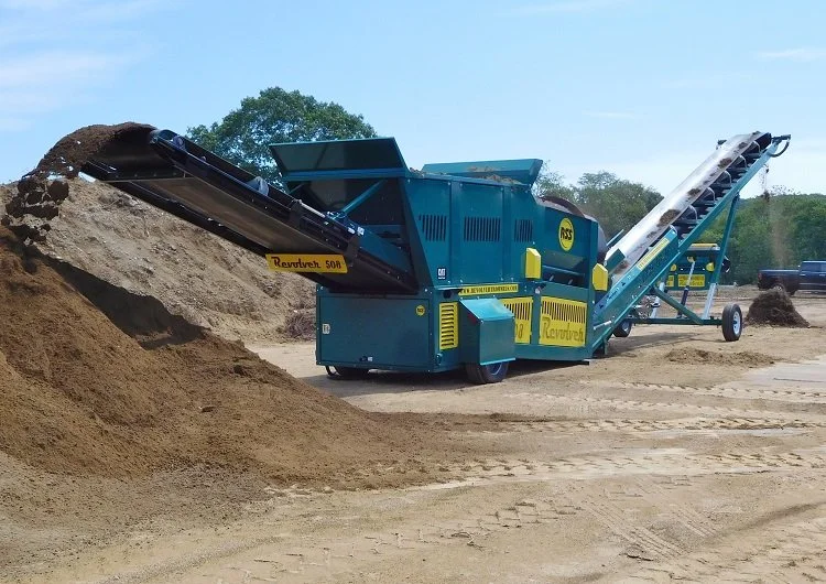 Industrial sand and gravel screening machine processing materials outdoors.