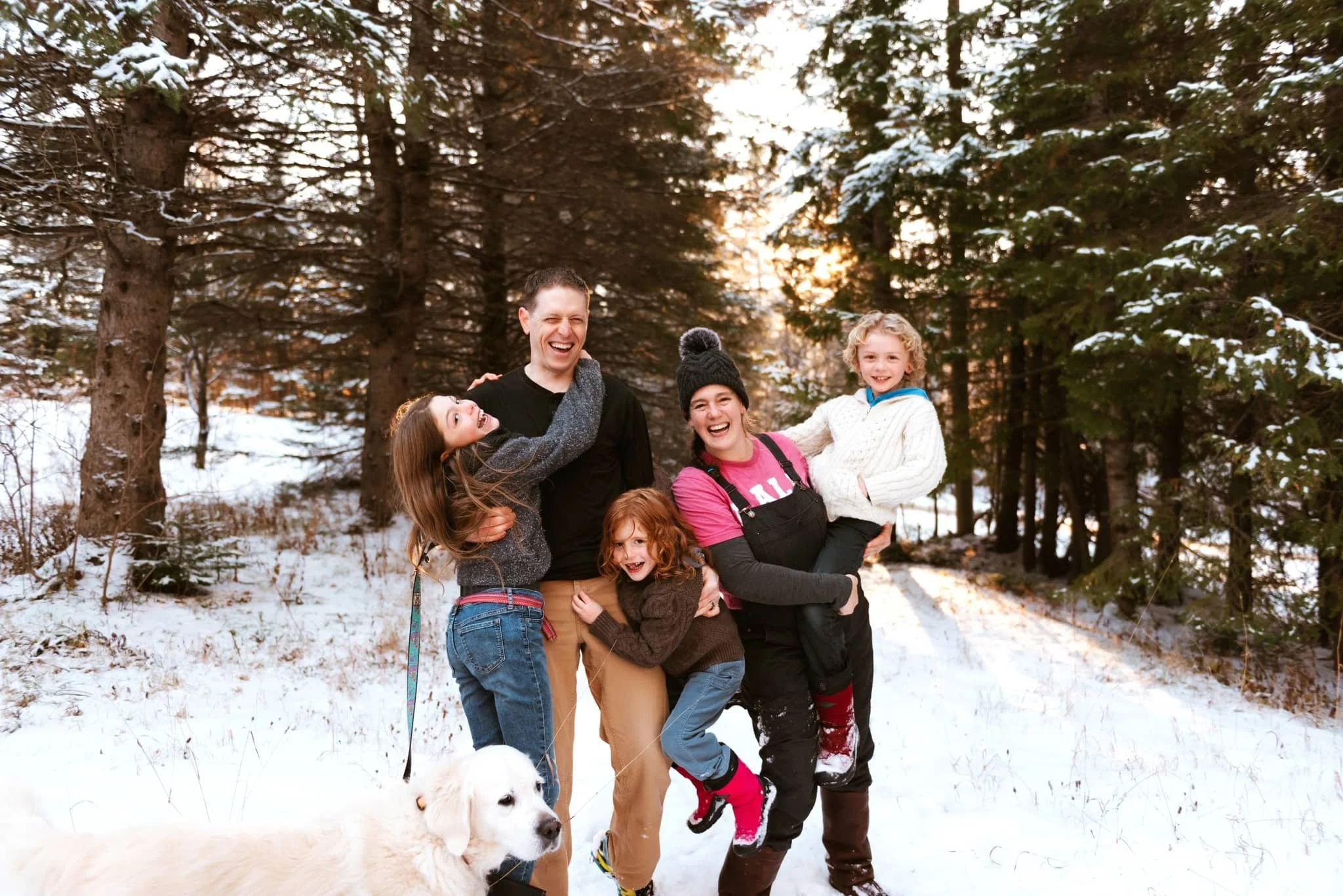 Ottawa-Gatineau area family in the forest smiling and looking playful.