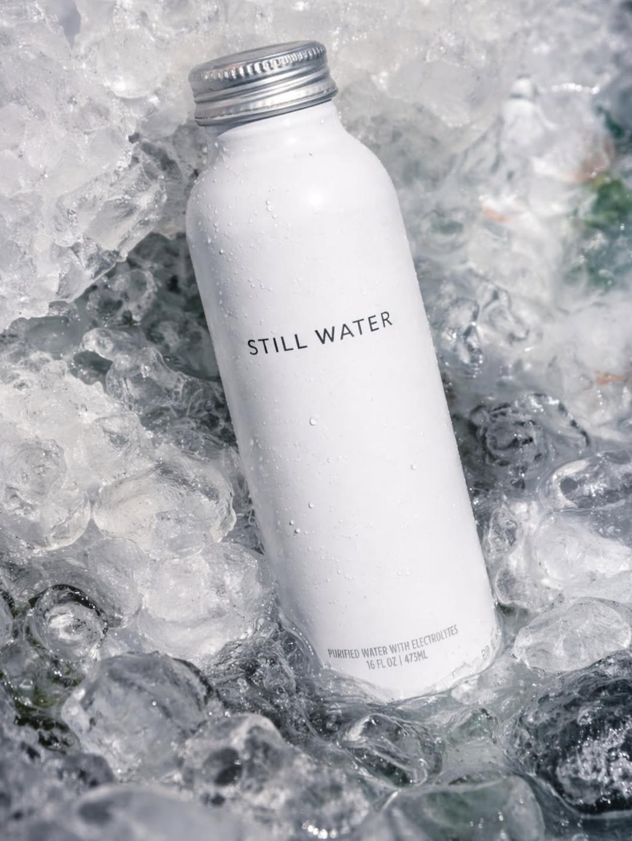 Custom branded aluminum water bottle labeled Still Water on a bed of ice