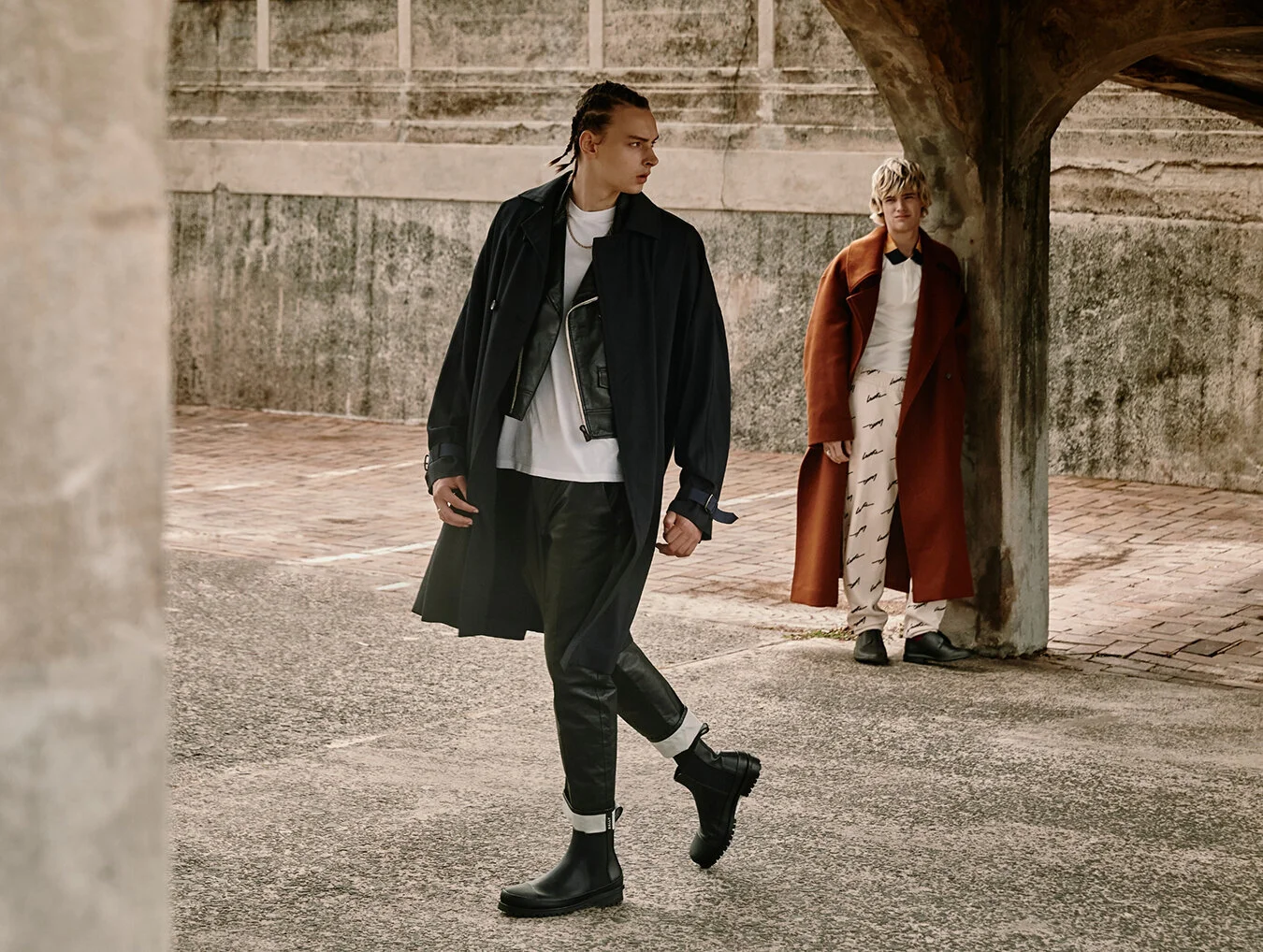 Finn (left): T-shirt, pants, jacket and mac Bally // Jude (right): Pants, top and sneakers Bally, Coat COS