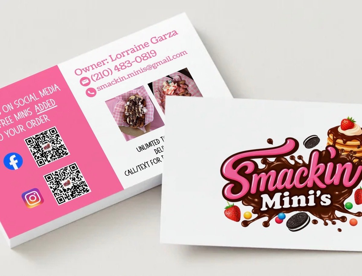 Business cards for Smackin Mini's, featuring a colorful logo with pink and brown chocolate splash, strawberries, cookies, and mini pancakes with syrup and a strawberry topping.