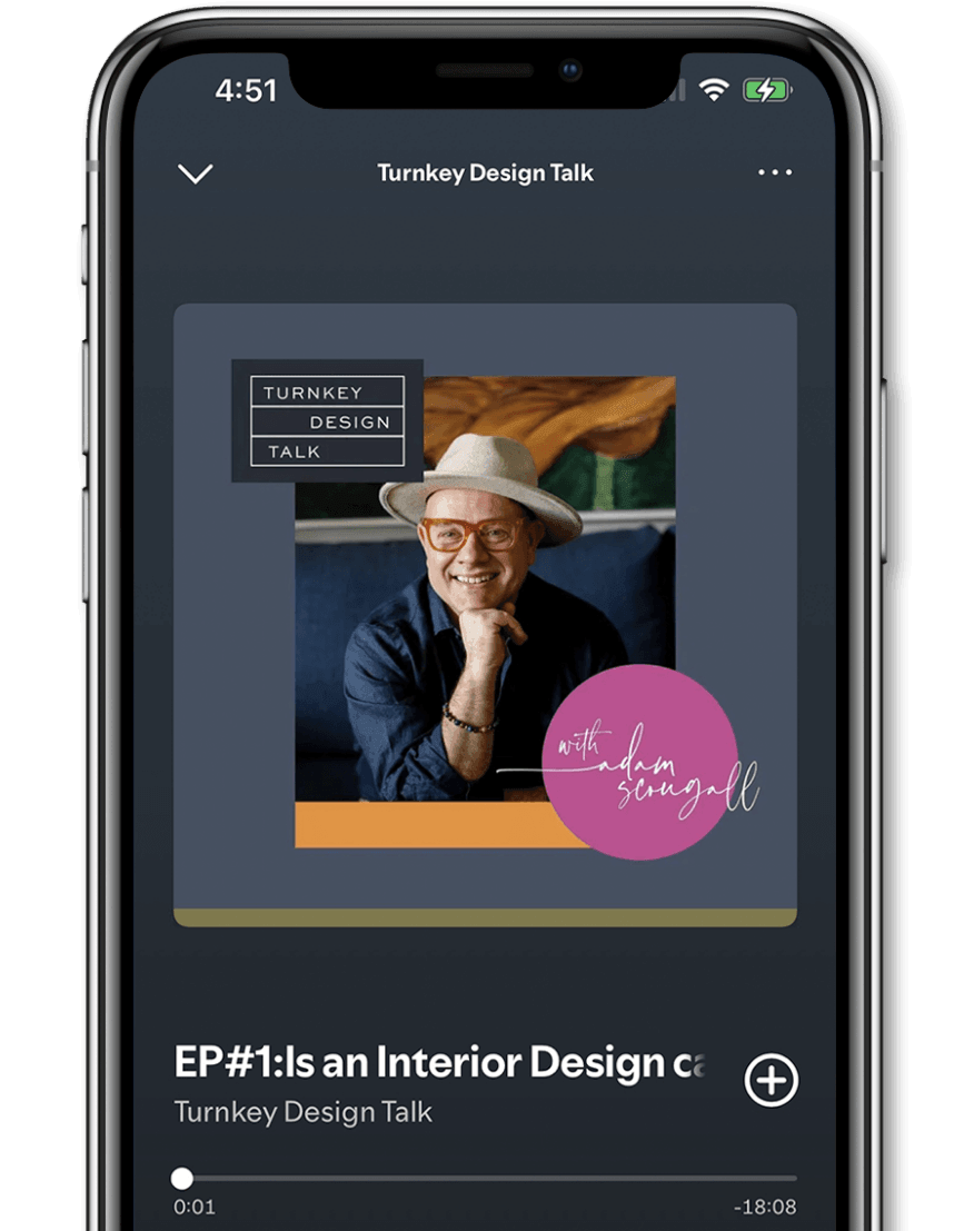 A smartphone screen displaying a podcast titled 'Turnkey Design Talk' featuring Adam Scougall wearing a beige hat, and a dark blue shirt, sitting indoors with a wooden sculpture in the background.
