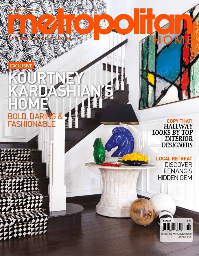 Magazine cover of 'Metropolitan Home' featuring a modern interior with a staircase, abstract artwork, and decorative objects, including blue horse sculpture, green figure, and round vase.