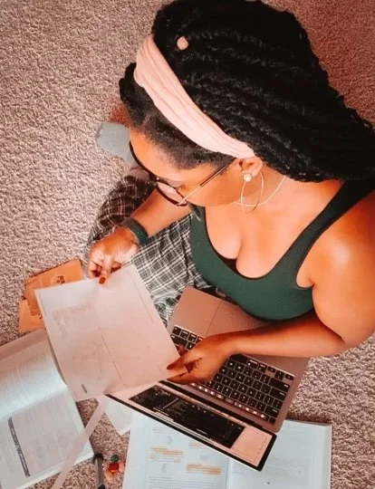 Woman studying astrology charts on floor