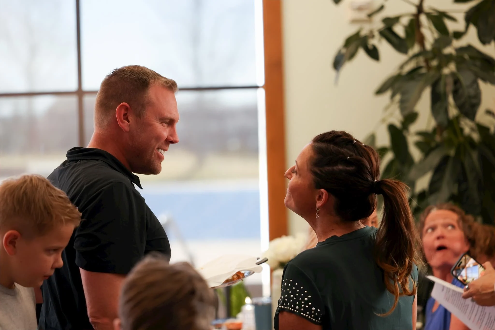 Two professionals networking at an indoor business event.