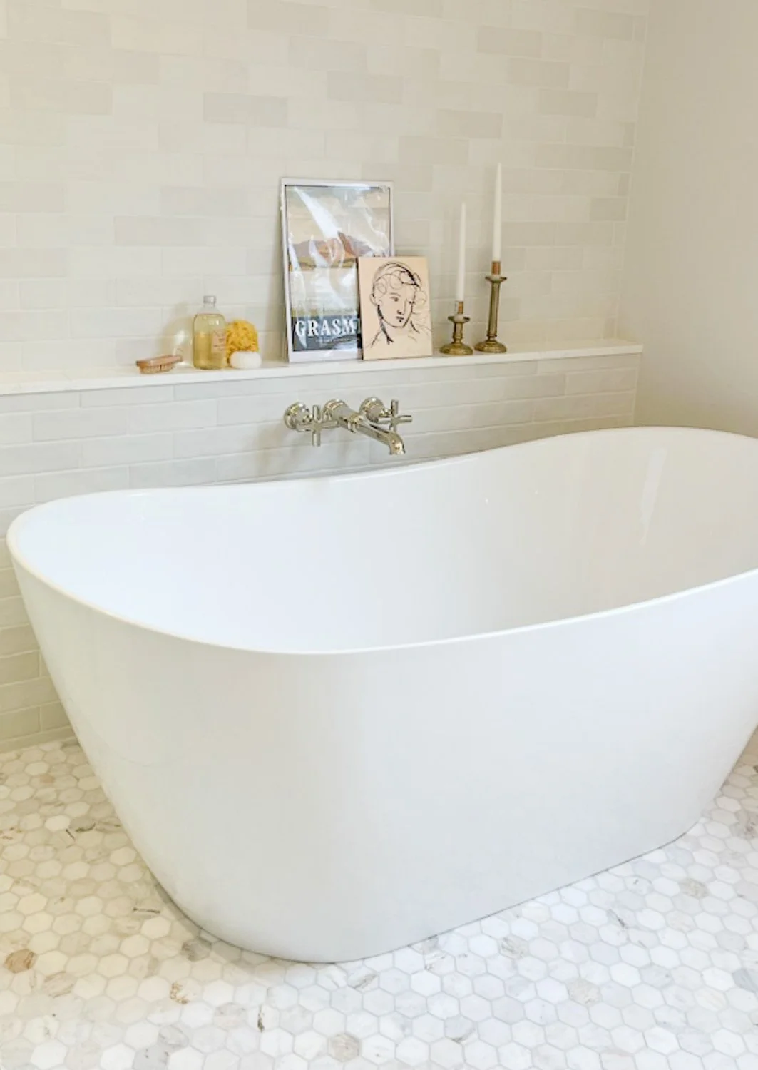 bathroom renovation with marble hexagon floor, freestanding tub and wall-mounted tub filler by maggie venne