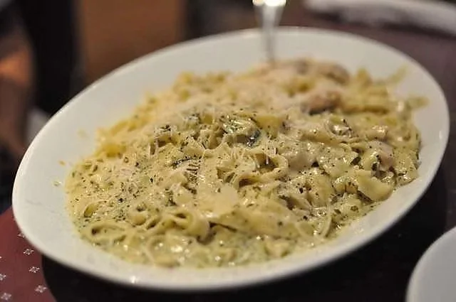 Creamy mushroom fettuccine pasta on a white oval plate