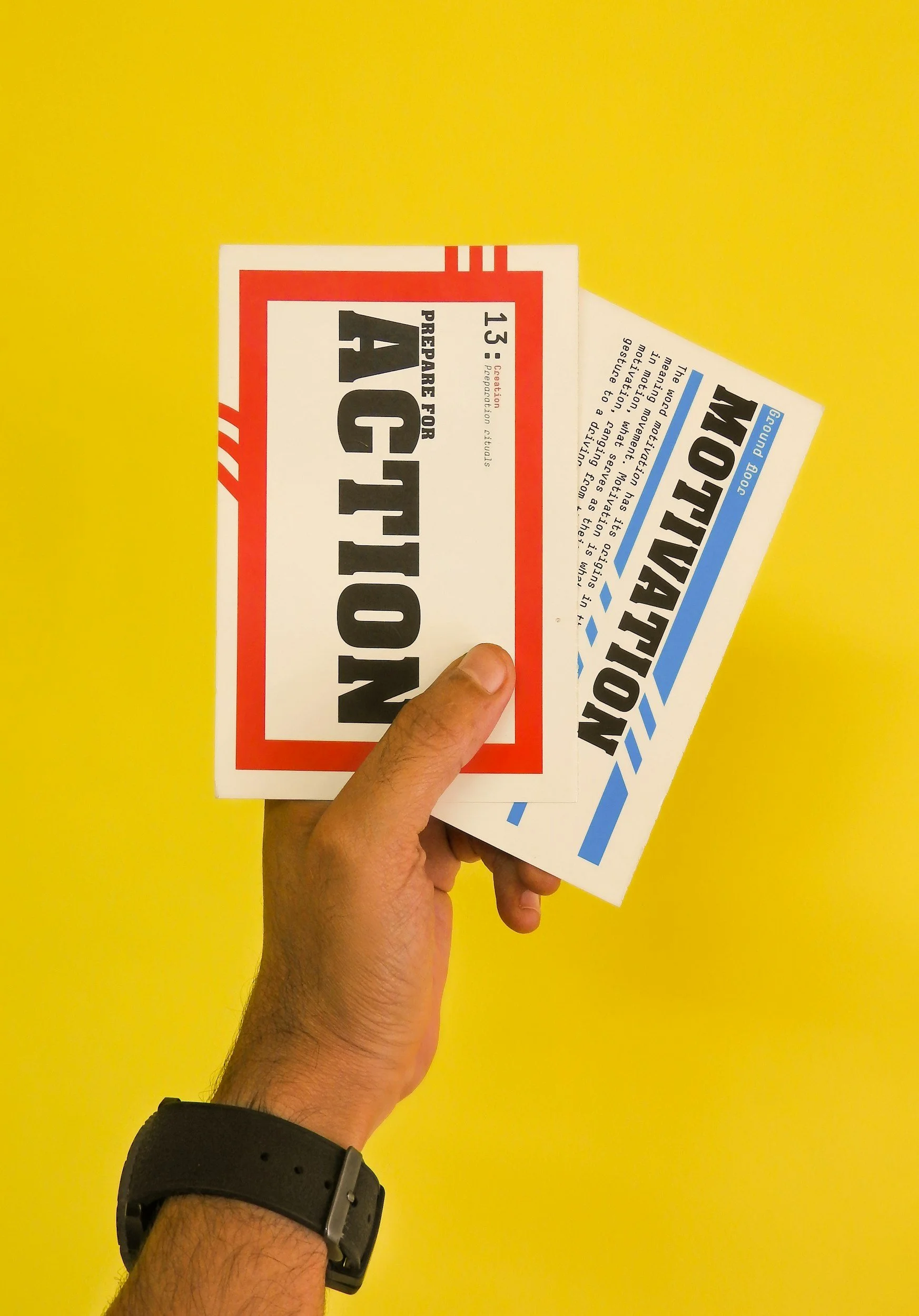Hand holding two tickets for a show or event against a bright yellow background.