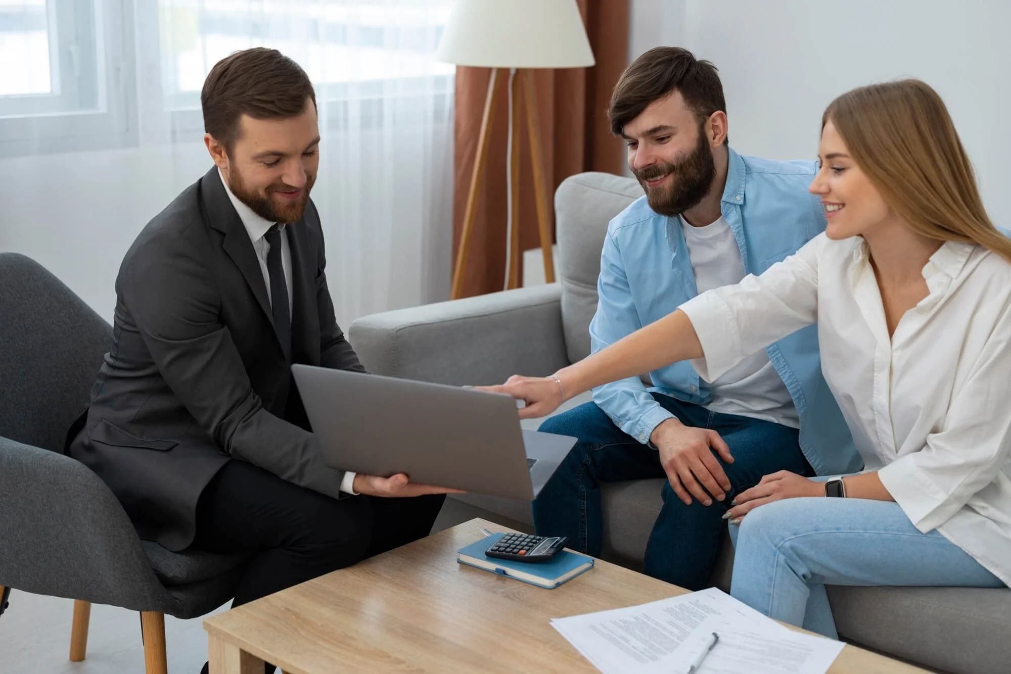 A couple meeting with a professional in a living room setting.