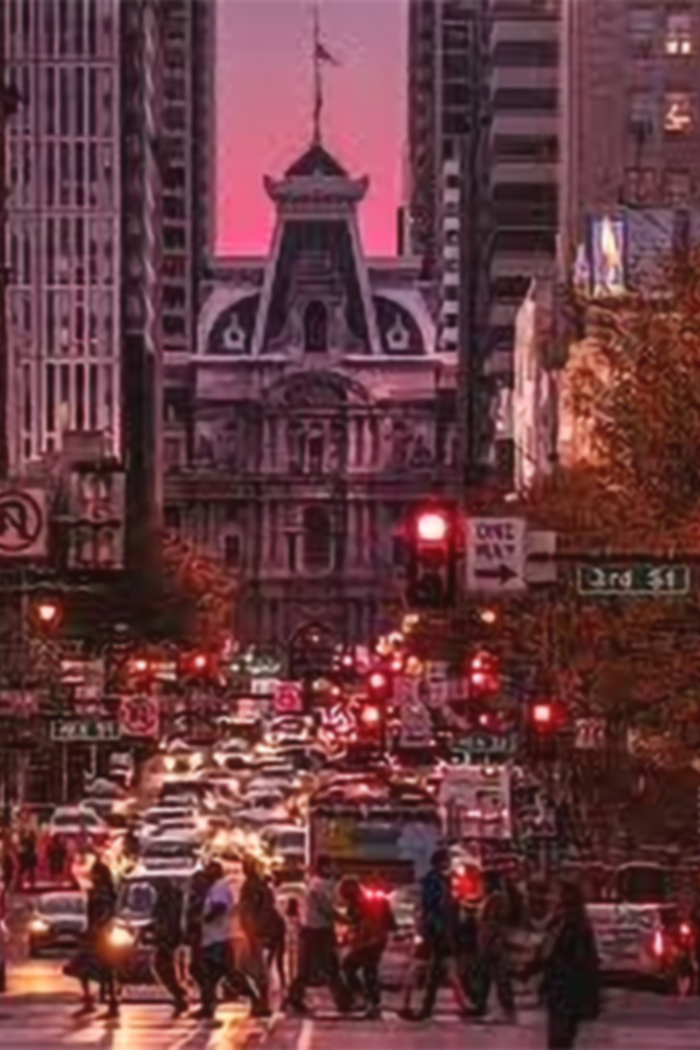 East Market and Philadelphia City Hall at dusk with cars, pedestrians, a backdrop for public art projects led by Philadelphia Public Art Associates.