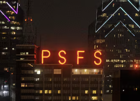 Night cityscape with a tall building featuring a bright red neon sign displaying the letters 'PSF' and with illuminated windows and other neon lights on nearby buildings.