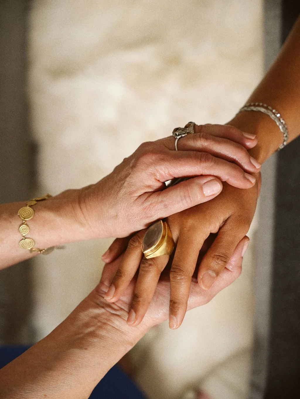 Practitioner holding client's hands for intuitive channeling, to reveal guidance and truth, reconnecting you with the deeper intelligence